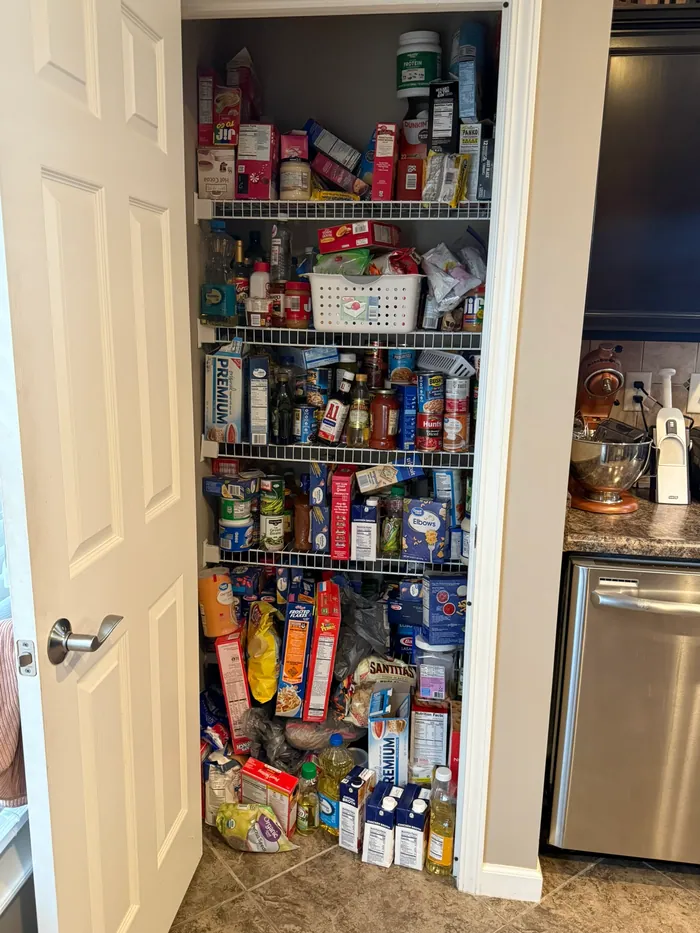 Original pantry before, with mixed storage and items on the floor